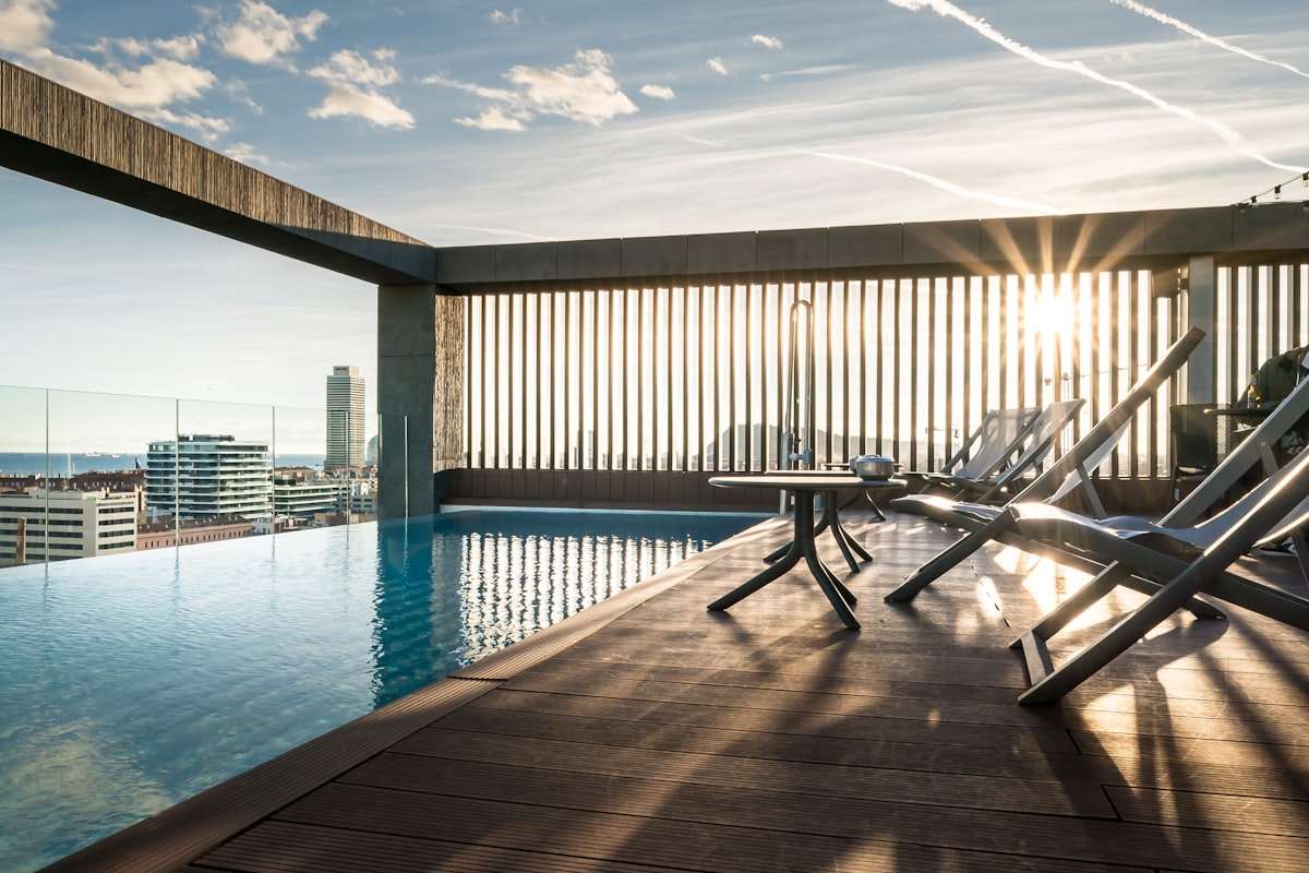 A modern pool deck with built-in lounge seating